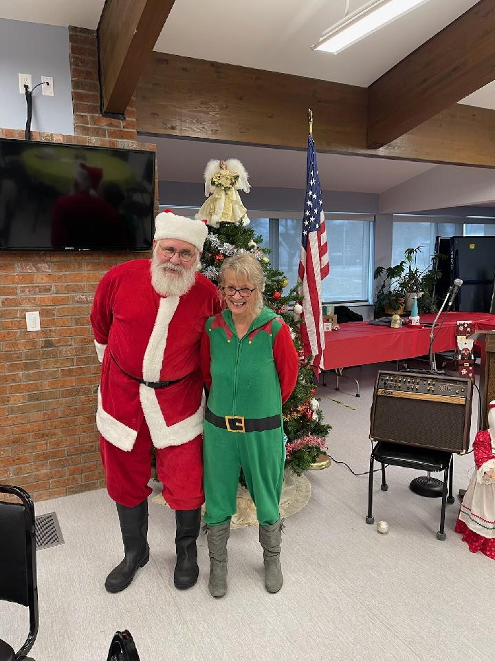 Jim and Sue with Santa at a fellowship event.